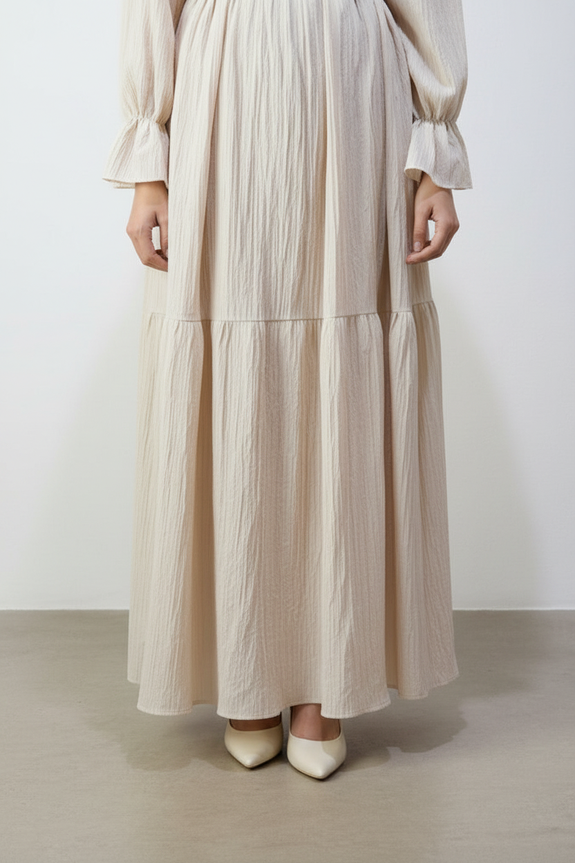 Cream dress bottom detail with matching background